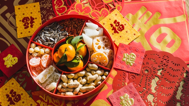 candy box with variety of Chinese new year snacks and Chinese new year decorations