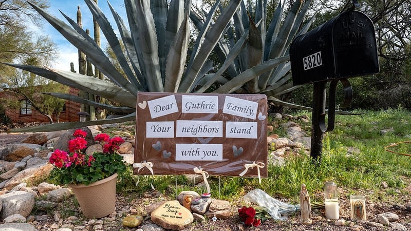 A makeshift memorial is stationed at the entrance to Nancy Guthrie's residence