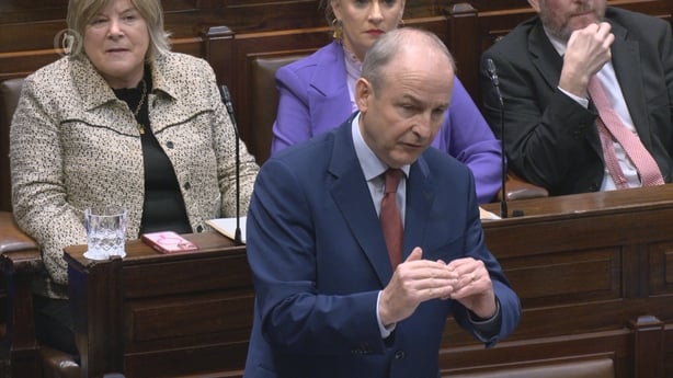 Micheal Martin gestures as he speaks in the Dail as other TDs watch on 