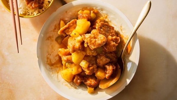 A bowl of crispy pork with fruit