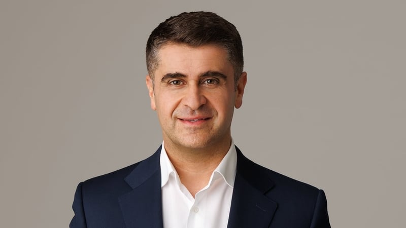 Headshot of Ahmad Younis, CEO of the Arab Irish Chamber of Commerce wearing a white shirt and navy jacket