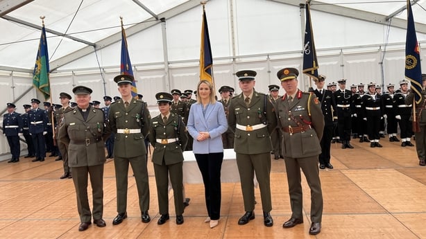 Six people stand in a line at an event