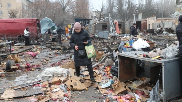 A woman walks through the aftermath of a Russia drone attack in the city of Odesa, Ukraine