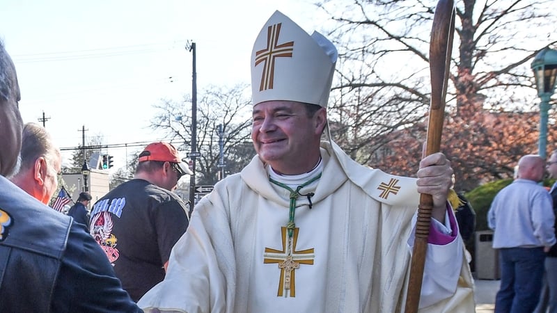 Bay Shore, N.Y.: Auxiliary Bishop Robert Brennan of the Diocese of Rockville Centre greets workers as they arrive for the Workers Memorial Mass where they will have a Blessing of the hardhats at Saint Patrick's Church in Bay Shore, New York on May 1, 2018