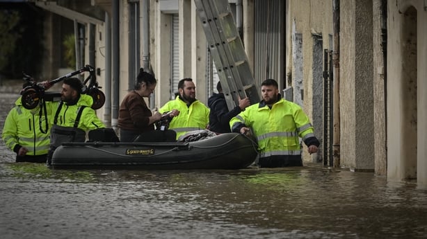 Emergency services evacuate in an inflatable boat a resident from her home in La Réole, south-western France
