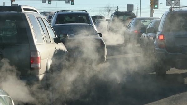 At an intersection in Denver, Colorado, exhaust pours out of a tailpipes