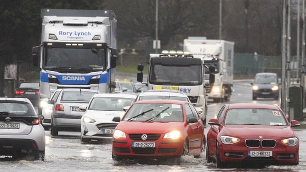 cars are driven through floodwaters in Swords in Dublin 