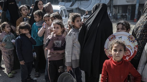 GAZA CITY, GAZA - FEBRUARY 12: Children line up as a charity distributes food to displaced Palestinians in the Rimal neighborhood of Gaza City as the food shortage continues due to Israel's blockade and restrictions on aid entering the Gaza Strip on February 12, 2026. (Photo by Ahmed Jihad Ibrahim A