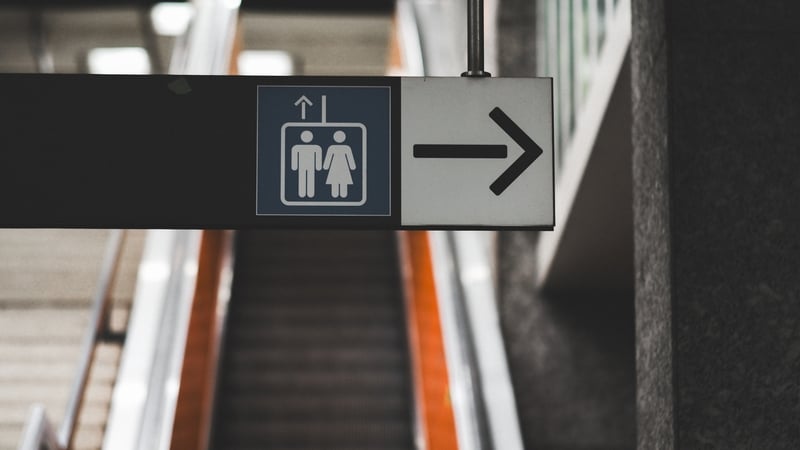 Elevator with a toilet sign
