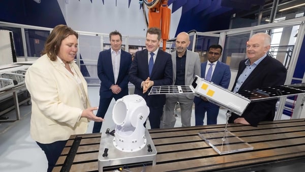 A woman and five men stand in a lab