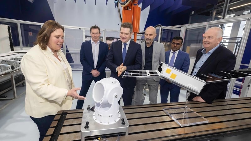 A woman and five men stand in a lab