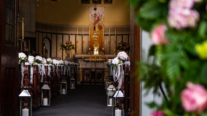 Interior of a catholic church, beautifully decorated with flowers for a wedding ceremony