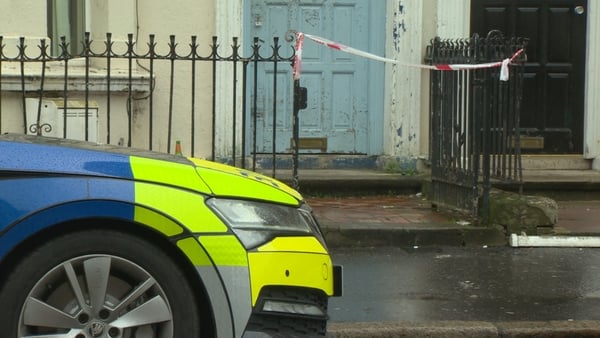 Police are seen outside the seen in south Belfast