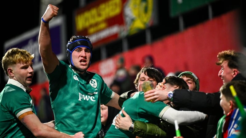 Derry Moloney of Ireland, second from left, celebrates with team-mates and supporters after his second-half try against Italy