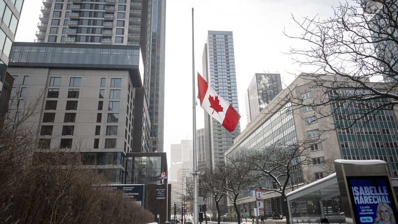 MONTREAL, CANADA - FEBRUARY 11: A Canadian flag is lowered at half-staff at the Guy-Favreau Complex on February 11, 2026 in Montreal, Canada. Canadian Prime Minister Mark Carney announced that flags will be lowered on all federal buildings for a week in m
