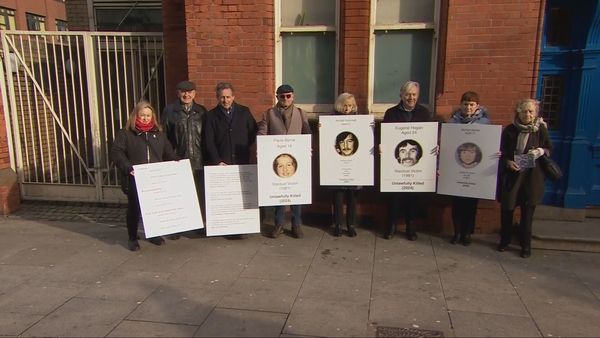 Relatives of Stardust Fire victims hold pen portraits of their dead love ones
