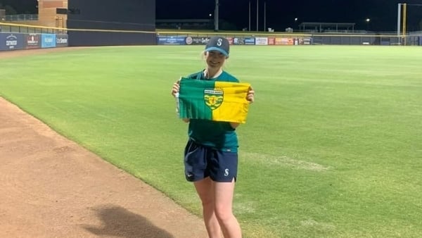 Rachel Boner holding a Donegal flag on a baseball pitch