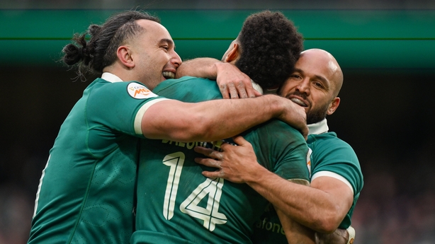 Robert Baloucoune of Ireland, 14, celebrates with teammate James Lowe, left, and Jamison Gibson-Park after scoring their side's third try during the Guinness 6 Nations Rugby Championship match between Ireland and Italy at the Aviva Stadium in Dublin. 