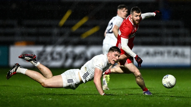Kildare's Brendan Gibbons is challenged by Niall Loughlin of Derry