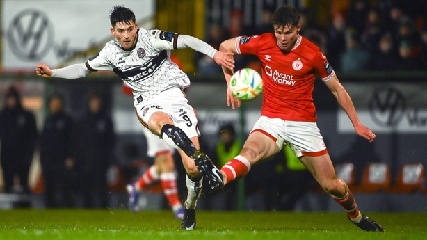 Colm Whelan has a shot on goal despite the attempts of Sligo's Gareth McElroy