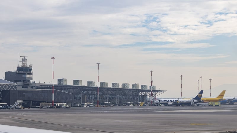The T1 airport terminal and control tower of Thessaloniki Airport. Passengers boarding a Boeing 737 MAX 8-200 passenger airplane of Ryanair low cost airline carrier at Thessaloniki Makedonia International Airport SKG. The plane is scheduled for a flight t