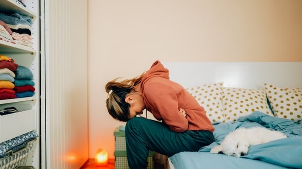 Young woman with painful menstruation resting in bed