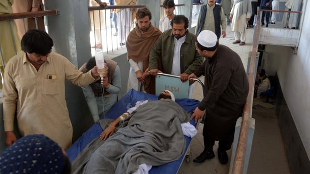 relatives carrying an injured blast victim inside a hospital in Bannu city of Pakistan's Khyber Pakhtunkhwa province