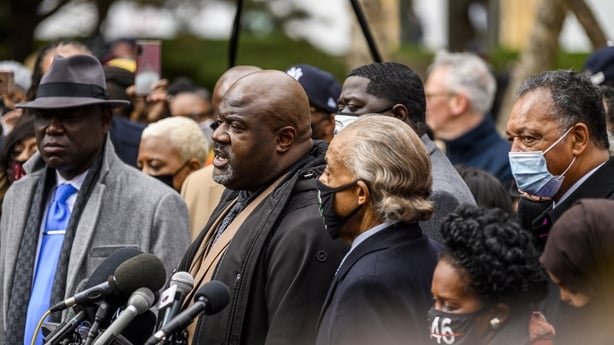 a group of people address a press conference in the US