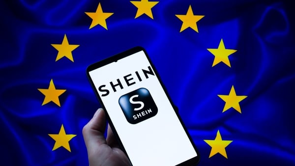 Shein logo seen on mobile phone with the European Union flag in the background