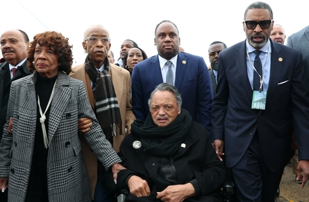 a group of people, with jesse jackson seated in a wheelchair, pictured in Selma alabama