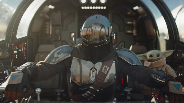 (L-R) Mandalorian (Pedro Pascal) and Grogu in the cockpit in Star Wars: The Mandalorian and Grogu