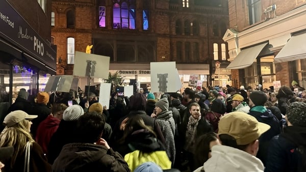 People attend a protest outside the Hoxton Hotel in Dublin