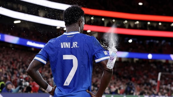 A supporter of Benfica throws a bottle of drink at Vinicius Junior of Real Madrid while hes about to take the corner during the UEFA Champions League match between Benfica v Real Madrid at the Estadio Da Luz on February 17, 2026 in Lisbon Portugal (Photo
