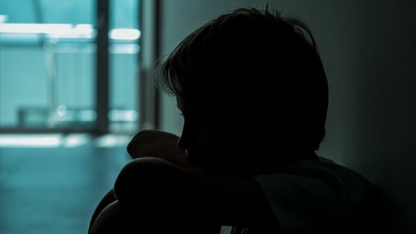 Sad boy sitting on the floor