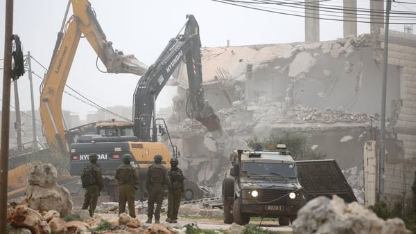 NABLUS, WEST BANK, PALESTINE - 2026/02/17: Israeli soldiers guard Israeli army bulldozers as they demolish a house in the al-Ta'awun neighborhood of Nablus in the West Bank. The Israeli army demolished five Palestinian homes in areas under the control of