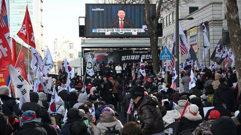 Supporters of former president Yoon Suk Yeol watch a live stream of the trial near the courthouse in Seoul