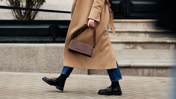 close up of woman's legs, walking street in fashionable autumn clothes
