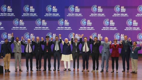 India's Prime Minister Narendra Modi (C) takes a group photo with AI company leaders at the AI Impact Summit in New Delhi on February 19, 2026. (Photo by Ludovic MARIN / AFP)