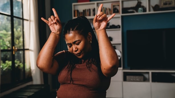 Portrait of a young adult woman celebrating good news at home