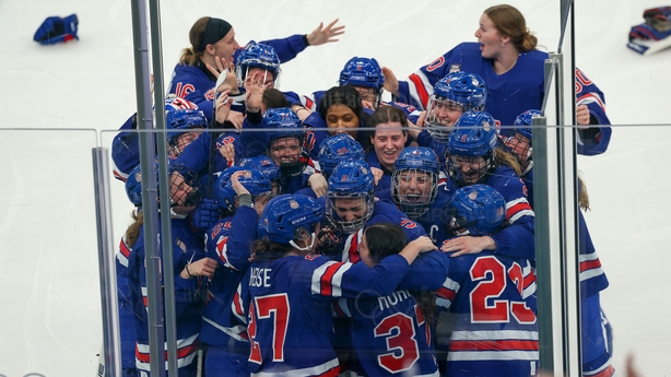Megan Keller #5 of Team United States celebrates with teammates after scoring the game-winning goal in overtime during the Women's Gold Medal match between the United States and Canada on day thirteen of the Milano Cortina 2026 Winter Olympic games at Milano Santagiulia Ice Hockey Arena on February 