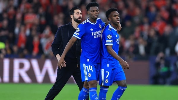 Real Madrid coach Alvaro Arbeloa, Aurelien Tchouameni walk with Vinicius Junior during Champions League play-off match against Benfica - February 2026