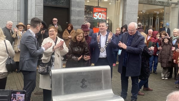 People at a memorial to honour the late Bagatelle frontman and Dundalk native Liam Reilly in his hometown