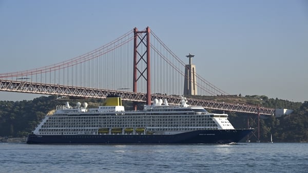LISBON, PORTUGAL - OCTOBER 09: Spirit of Adventure, a 58,199 GT cruise ship operated by Saga Cruises, sails under 25 de Abril Bridge while navigating the Tagus River after leaving the cruise terminal on October 09, 2025, in Lisbon, Portugal. Tourism in Po