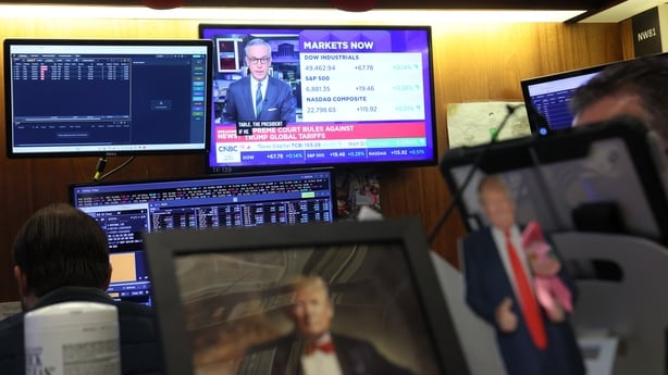NEW YORK, NEW YORK - FEBRUARY 20: News of the Supreme Court ruling on tariffs is seen on a television as traders work on the floor of the New York Stock Exchange during morning trading on February 20, 2026 in New York City. Stocks opened up mixed with the Dow Jones nearly 200 points at opening amid 