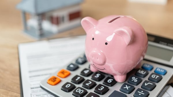 stock photo of a piggy bank on top of a calculator
