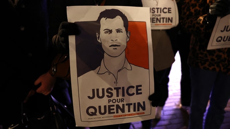 A demonstrator holds a portrait during a rally in tribute of Quentin Deranque in Lille