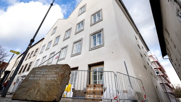 Picture taken on February 17, 2026 shows a memorial stone reading "For Peace, Freedom and Democracy - Never Again Fascism - Millions of Dead Warn" in front of the birth house of Adolf Hitler