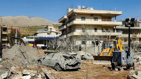 A bulldozer clears debris near heavily-damaged buildings in the village of Bednayel in Lebanon's eastern Bekaa Valley region on February 21, 2026, following Israeli strikes. Lebanon's President Joseph Aoun on February 21 condemned Israel's deadly attacks