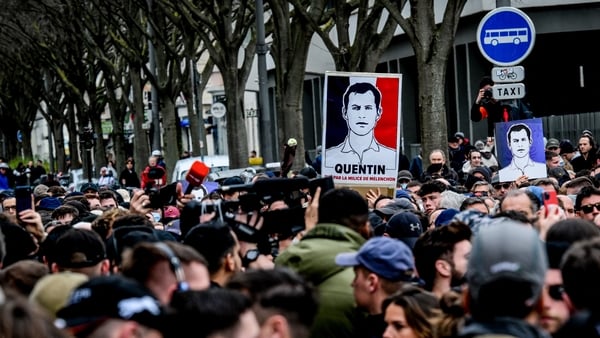 Protesters hold portraits of far-right activist Quentin Deranque during a march in France