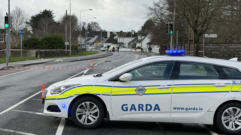 a garda car in the foreground on a road with garda cars in the background